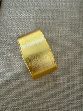 Load image into Gallery viewer, A gold cuff
