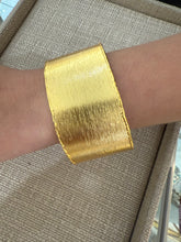 Load image into Gallery viewer, A gold cuff
